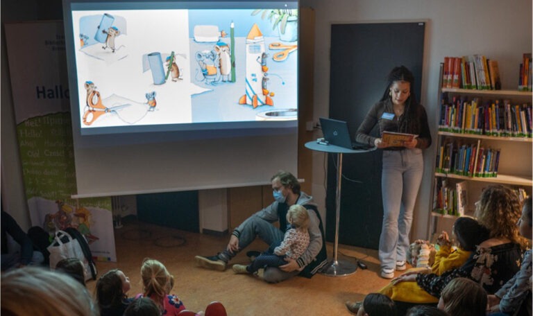 Children watch a picture book cinema.