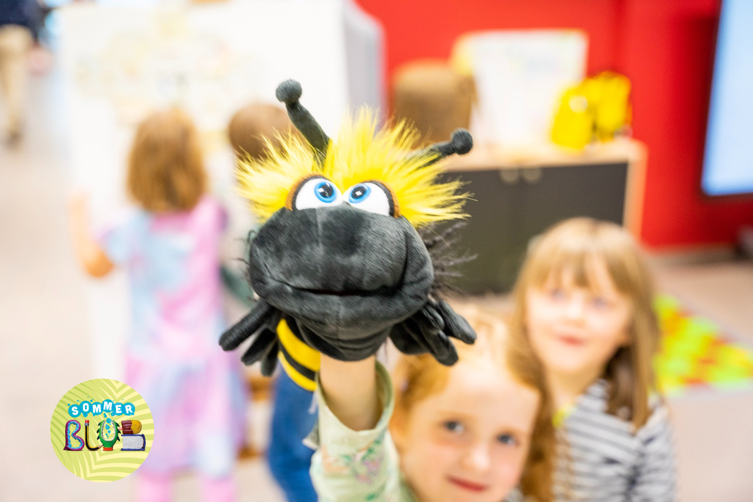 A child holds a stuffed toy bee into the camera