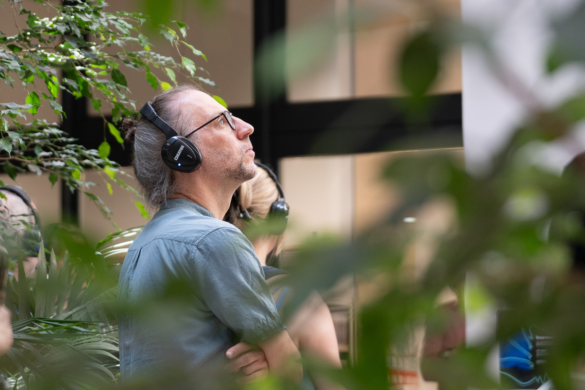 A person with headphones at the opening of the listening venue