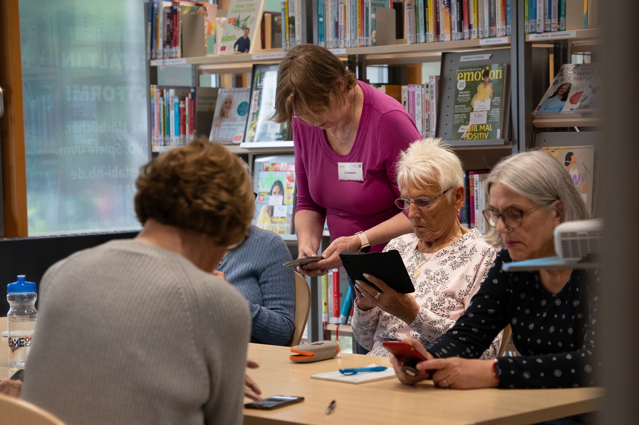 A library employee advises a customer